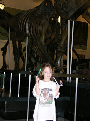 Peo stands in front of the last fossil on the path with her completed journal in her hand.